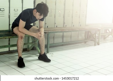 Young Asian Man Sitting Taking Break Upset Or Tired. ,sweating After A Workout Session At Gym Or University Sport Competition. Athlete Suffering Breakdown To Overcome. Stress And Fatigue In Sport. 