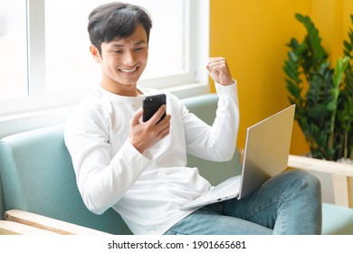 Young Asian man sitting working at home
