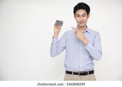 Young Asian Man Smiling, Showing, Presenting Credit Card For Making Payment Or Paying Online Business, Pay A Merchant Or As A Cash Advance For Goods, Cardholder Or A Person Who Owns A Card