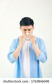 Young Asian Man Sneezing After Get Allergy Or Flu Virus And Using Tissue Paper For Swipe On Nose At Medical Clinic After Got Coronavirus (covid-19) Disease For Unhealthy Lifestyle Concept