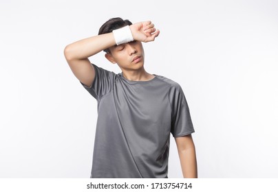 Young Asian Man In Sport Outfits Tired After Exercise Isolated On White Background.