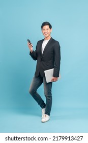 Young Asian Man In Suit And Jeans For Smart Casual Business Concept Isolated On Blue Background