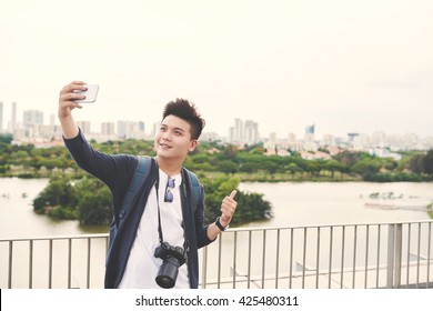 Young Asian Man Taking Selfie On The Background Of Big City