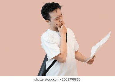 young asian man thinking of idea in isolated pink background