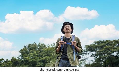 young Asian man traveler with backpack in reservoir - Powered by Shutterstock
