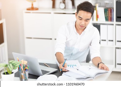 Young Asian Man University Student Working With Laptop Computer And Notebook , Self Learning And College Lifestyle Concepts