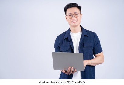 Young Asian Man Using Laptop On White Background