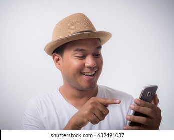 Young asian man using smartphone and Smiling