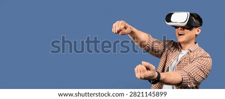 Young Asian Man Using Virtual Reality Headset And Gaming, Excited Expression, Indoor Setting