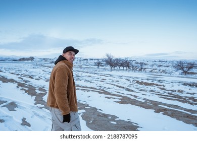 young asian man walking alone in beautiful snowy landscape