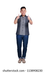 Young Asian Man Wearing Blue Jeans And Batik Shirt, Proud And Thumbs Up Gesture. Isolated On White. Full Body Portrait