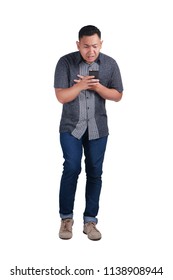 Young Asian Man Wearing Blue Jeans And Batik Shirt Shocked While Looking At His Phone. Isolated On White. Full  Body Portrait