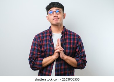 Young Asian Man Wearing Casual Shirt Standing Over White Background Thinking Worried About A Question, Concerned And Nervous With Hand On Chin