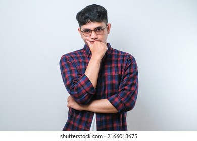 Young Asian Man Wearing Casual Shirt Standing Over White Background Thinking Worried About A Question, Concerned And Nervous With Hand On Chin