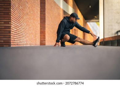 Young Asian Man Wearing Sportswear Running Outdoor. Portraits Of Indian Man Stretching Leg Before Running On The Road. Training Athlete Work Out At Outdoor Concept.