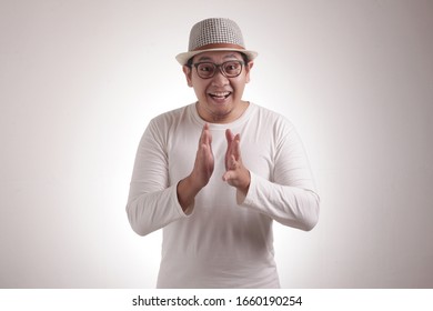 Young Asian Man Wearing White Shirt, Happy Proud Clapping Gesture.Over Grey Background, Halfl Body Portrait