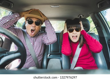 Young Asian Man And Woman Shocked Face While Sitting In Car.