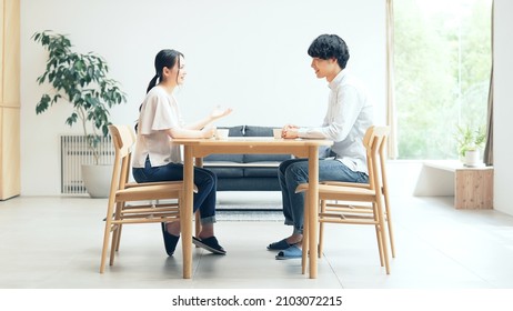 Young asian man and woman talking in the room. - Powered by Shutterstock