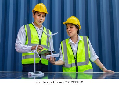 Young Asian Man And Woman University Students Learning And Experimental Wind And Sunlight Renewable Energy In Engineering, Bachelor Of Science, Renewable Energy Course. Education And Energy Concept.