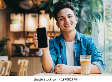 Young Asian man working at coffee shop - Powered by Shutterstock