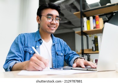 Young Asian Man Working At Office