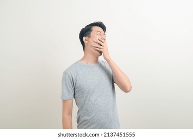 Young Asian Man With Yawn Face And Sleepy On White Background