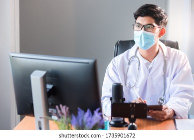 A Young Asian Medical Student Studied Medicine Through An Online Video Conferencing System Taught By An Asian Adult Doctor. Conferencing Concepts Or Online Video Conferencing Systems By Doctors