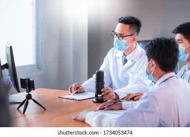 Young Asian Medical Students Study Medicine Through An Online Video Conferencing System Taught By Asian Adult Doctors. An Online Video Conference Or Education System Concept By A Doctor.