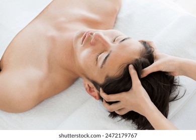 Young asian men are head massaged. - Powered by Shutterstock