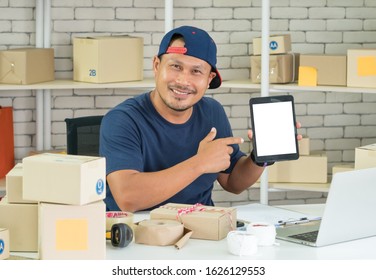 A Young Asian Merchant Is Smiling Happily. He Is A Small Business Owner. Selling Products Online