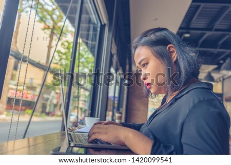 Young Asian millennial freelancer focus on working on laptop