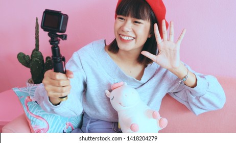 Young asian millennial woman taking selfie and live streaming at the cafe, lifestyle and technology concept - Powered by Shutterstock