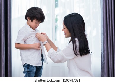 Young Asian Mom Dressed Up Son Outfits For Preparing Go To School. Mother And Son Concept. Happy Family And Home Sweet Home Theme. Preschool And Back To School Theme.