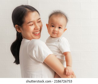 Young Asian Mom And Sweet Baby Daughter, Health Care Family Love Together. Asia Mother's Day Concept. Looking To Camera.