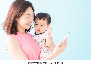 Young Asian Mother And Baby,smart Phone,