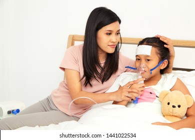 Young Asian Mother Child Sick Care At Home