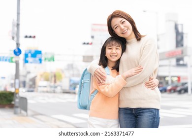 Young Asian Mother And Daughter , School Bag