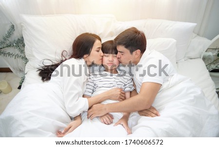 Similar – Relaxed mother and sons playing over the bed