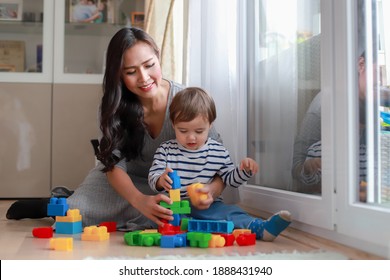 Young Asian Mother Playing With Construction Blocks Toy With Her Baby At Home Or Nursery Room. Happy Family Play And Learn Fine Motor Development.