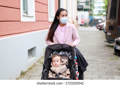 Young Asian Mother Wearing Medical Face Mask Walking On Street With Her Baby In Stroller During Coronavirus,covid-19 Pandemic Outbreak.mom And Son In Carriage.