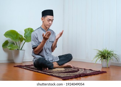 Young Asian Muslim Man Pray On The Prayer Rug At Home On Ramadan Kareem 