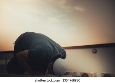 A Young Asian Muslim Man Praying On Sunset,Ramadan Festival Concept