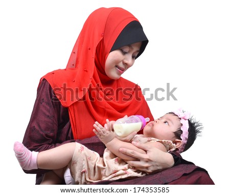 Young Asian muslim mother enjoying feeding her cute baby girl with a milk bottle isolated on white background