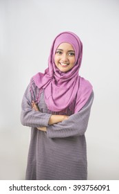 Young asian muslim woman in head scarf smile with arms crossed