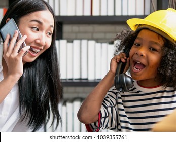 Young Asian Nanny Playing Telephone Calling With Cute Curly Hair Boy After School