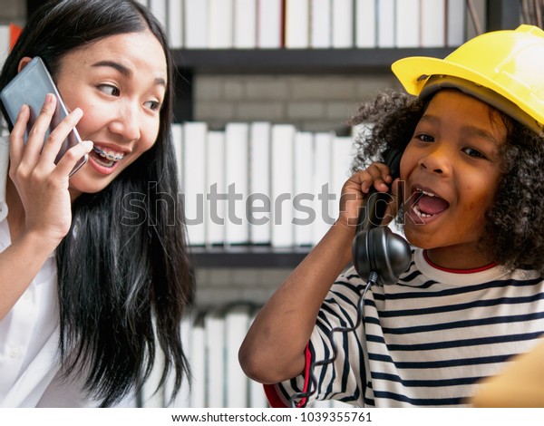 Young Asian Nanny Playing Telephone Calling Stock Photo