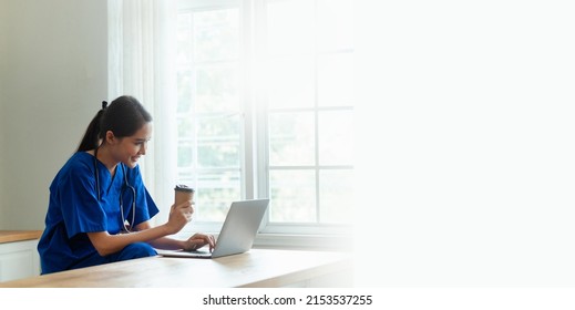 A Young Asian Nurse Confidently Works With Her Laptop In The Clinic.
Health Care Concept Happy Doctor Or Nurse In Hospital Banner Image