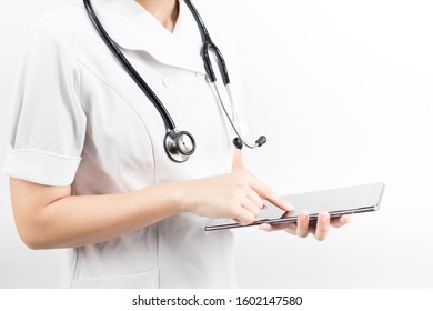Young Asian Nurse With A Stethoscope Using A Digital Tablet, Isolated Over White Background.