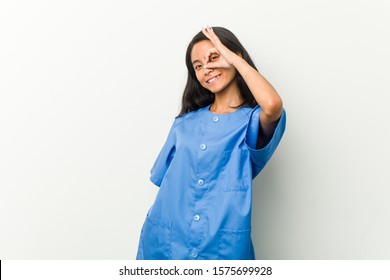 Young Asian Nurse Woman Excited Keeping Ok Gesture On Eye.