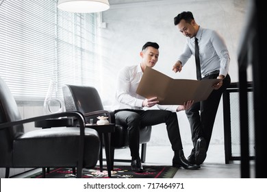 Young Asian Office Workers At Work.